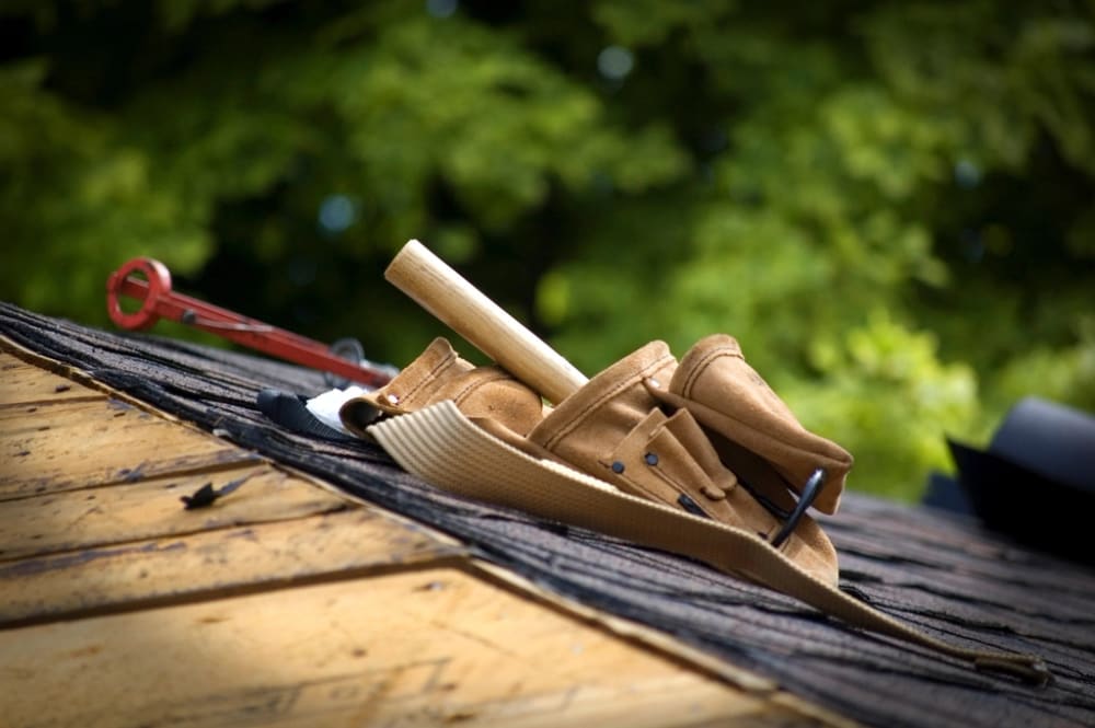 Roofing tools placed on asphalt shingles